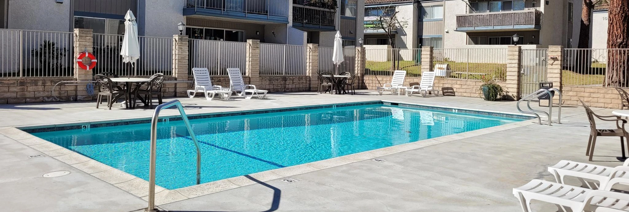 Ashwood Gardens Apartments fenced community pool with large trees